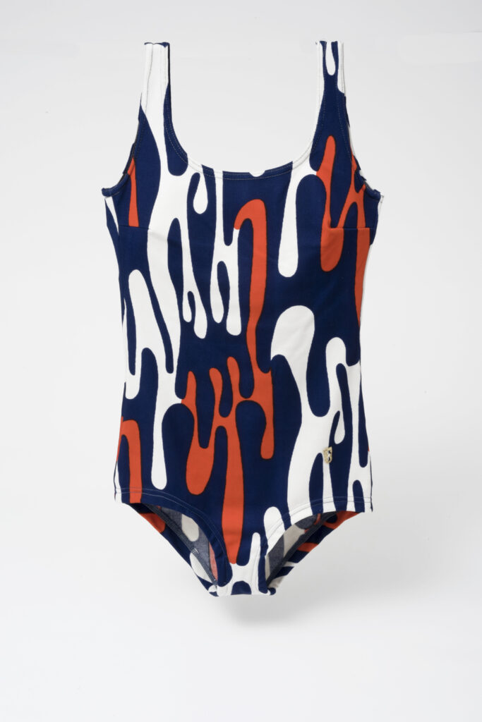 patterned bathing suit in orange, blue, white