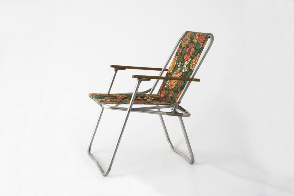 Folding chair with fabric seat, unfold, side view