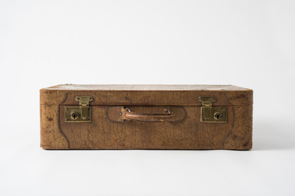 suitcase with a brown leather cover