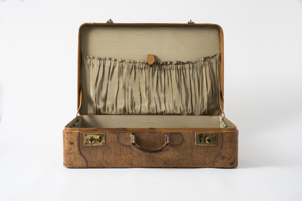 suitcase with a brown leather cover, textile lining