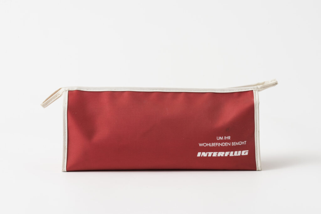 red toiletery bag from the airline Interflug, front with label