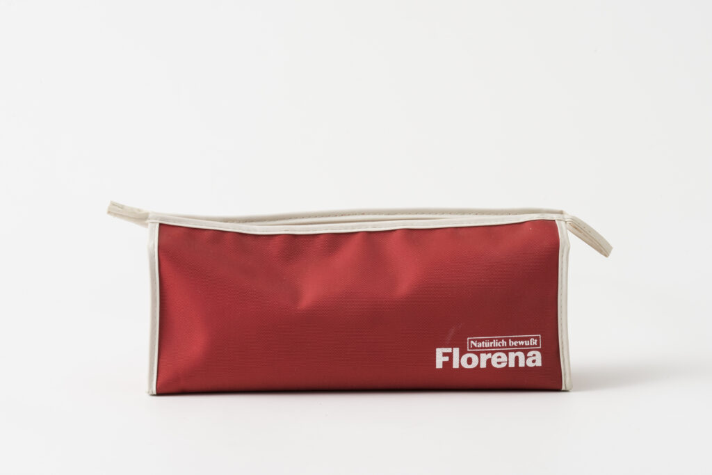 red toiletery bag from the airline Interflug, Backside with the label of the cosmetics brand Florena