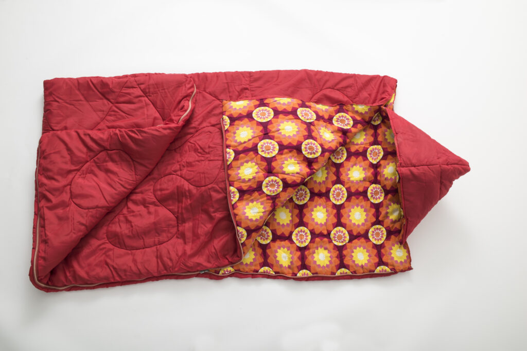 red sleeping bag with inner lining in a floral pattern