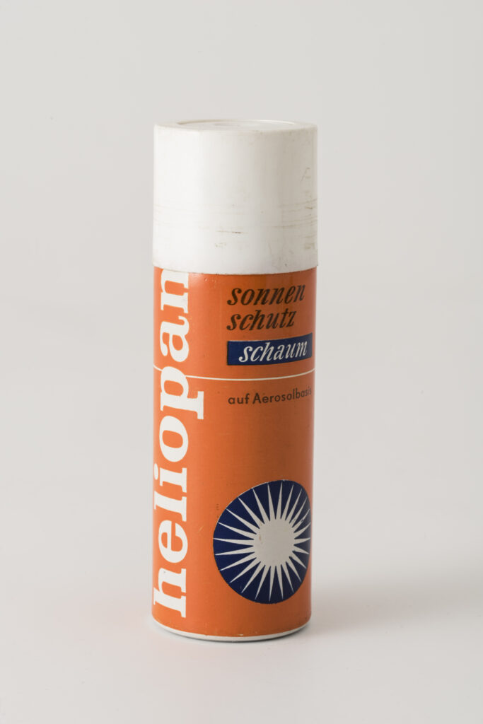 a can of the suncream heliopan, orange with a white plastic lid